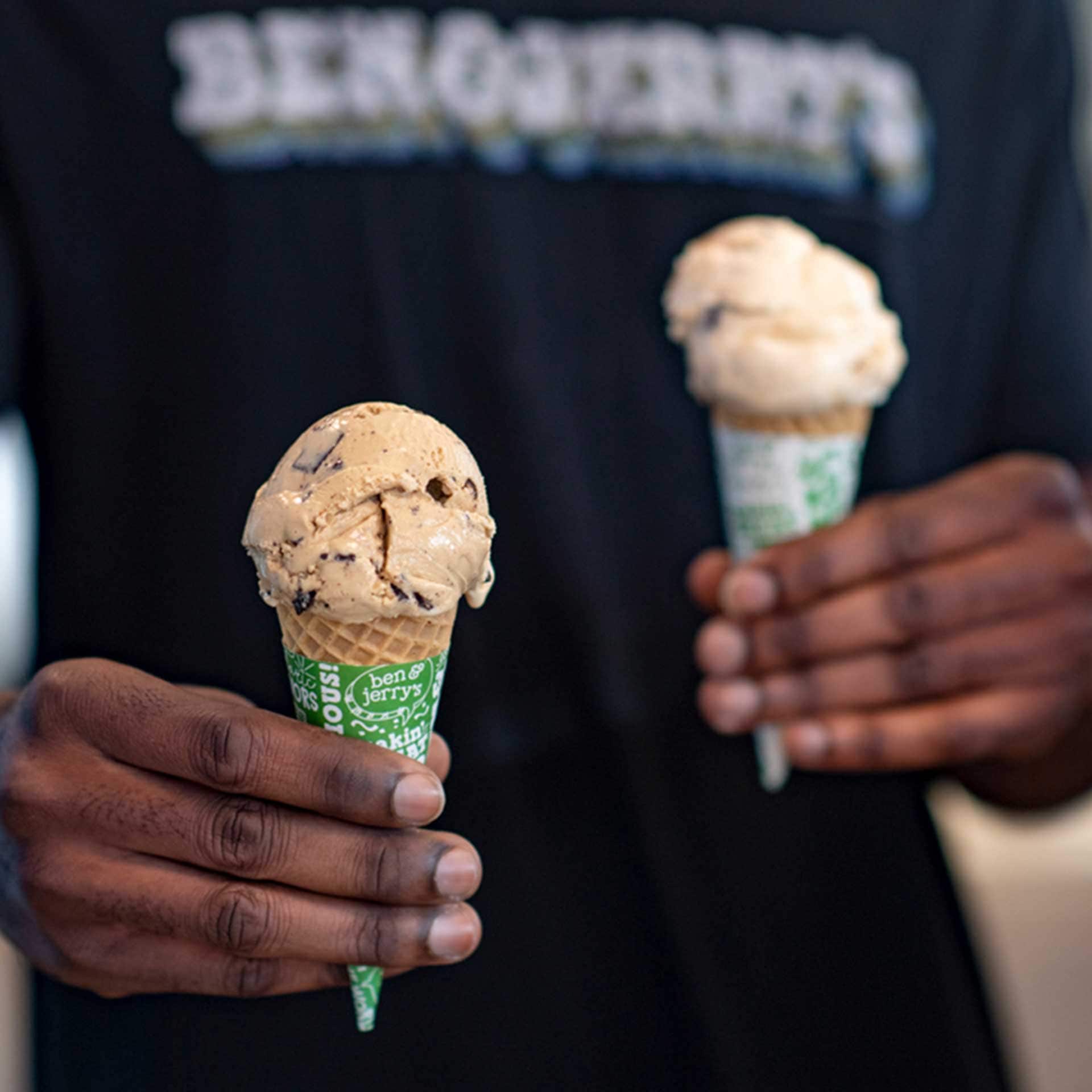 Hands holding two ice cream cones